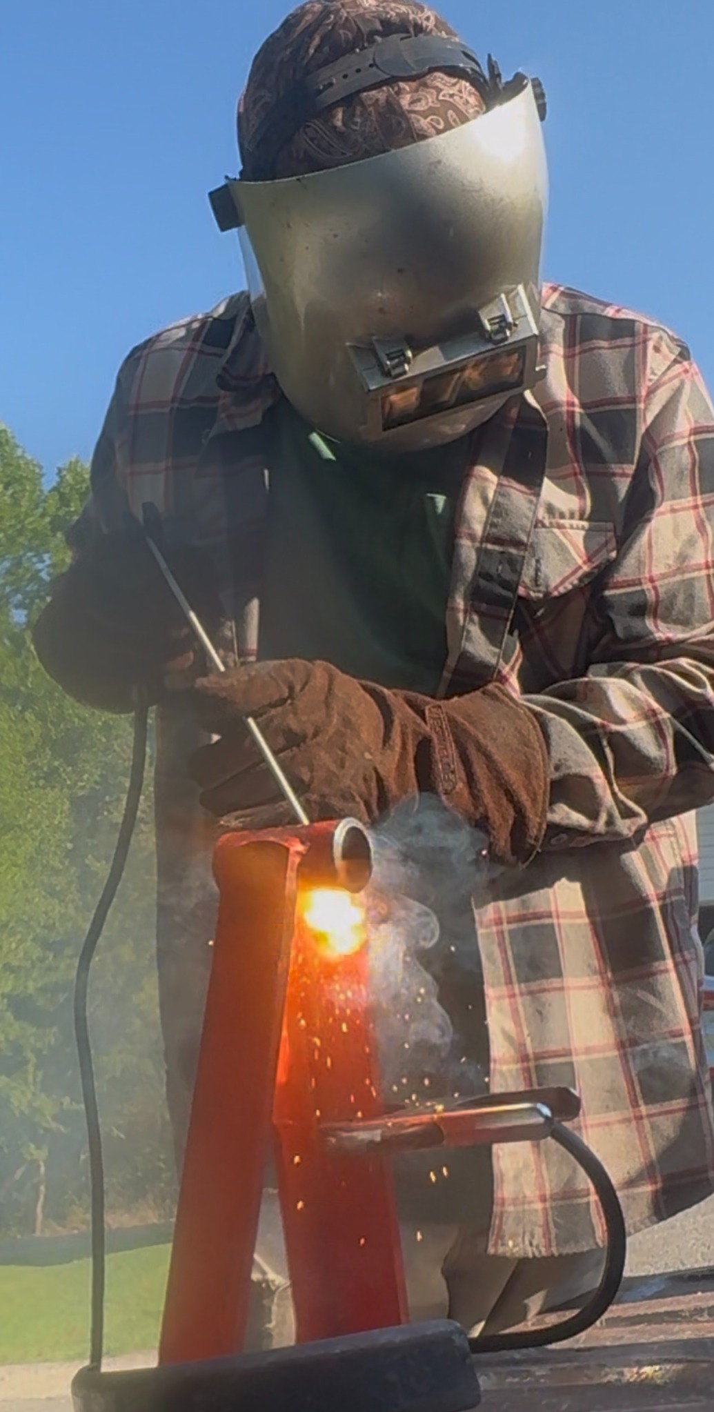 Glover Welding welder working on a steel repair outdoors